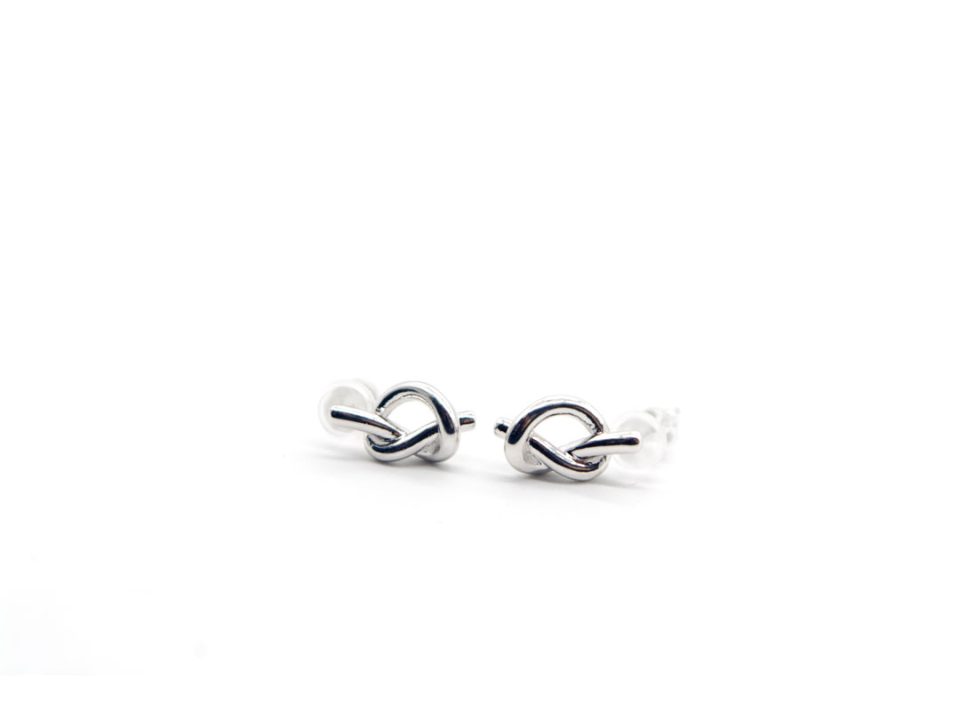 Studded silver earrings 925 in the shape of a knot silver color.