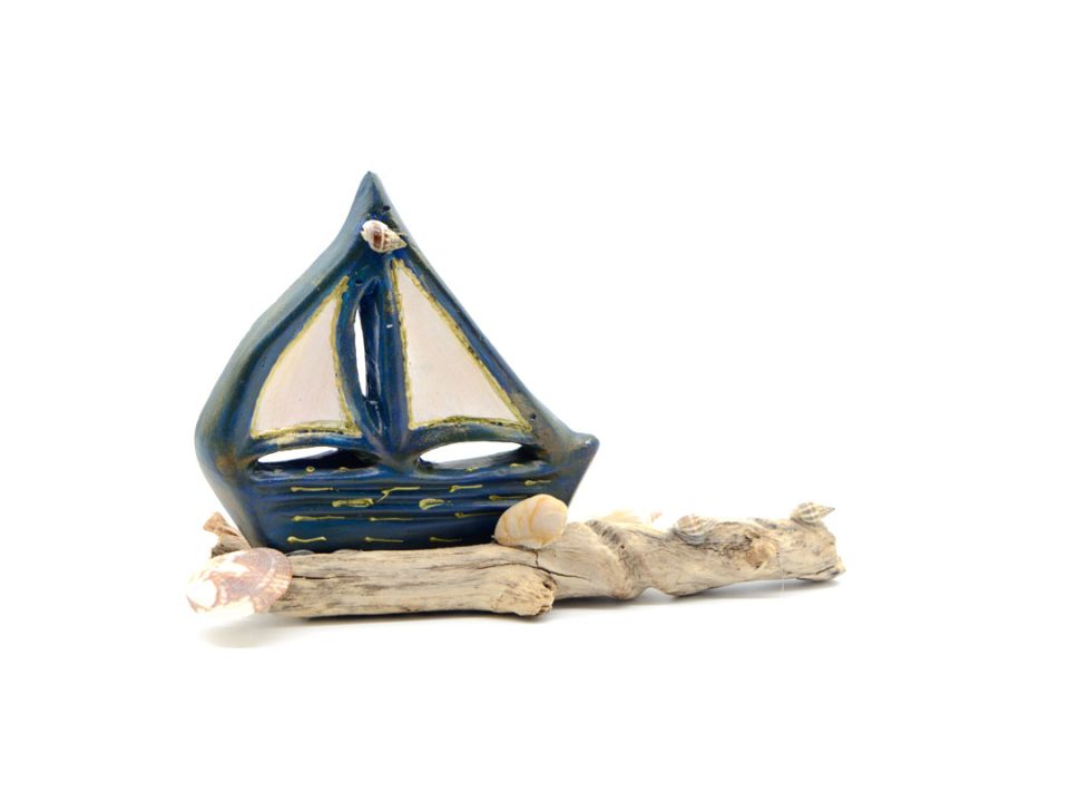 Handmade boat, blue white, on sea wood