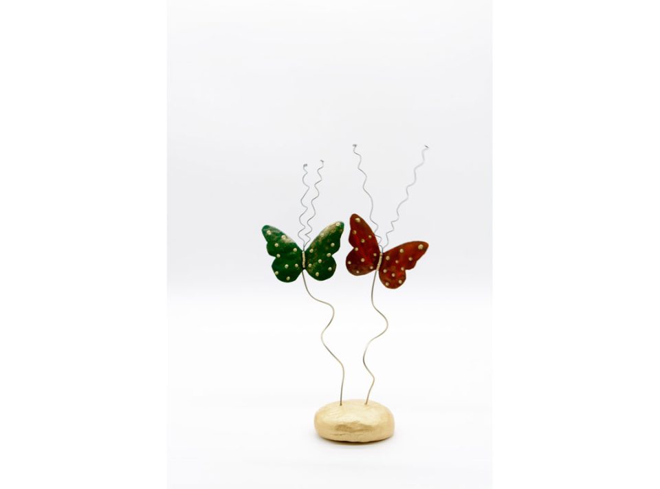 Handmade, metallic, forged bronze butterflies, painted in green and red on a clay base