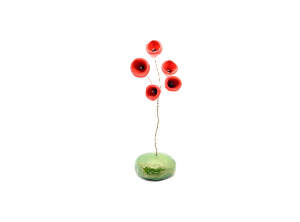 Handmade decoration from clay, small red flowers, on a base