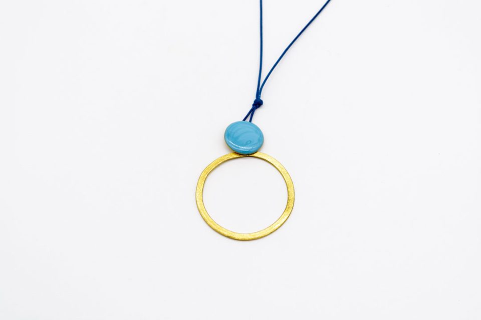 necklace forged gold element ring hung from round with light blue