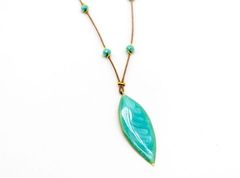 necklace with forged element in the shape of a large nail with bright green enamel