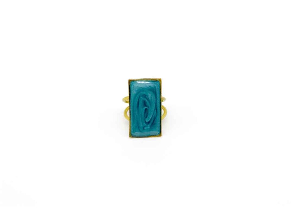 Handmade forged ring with rectangular pattern in turquoise.