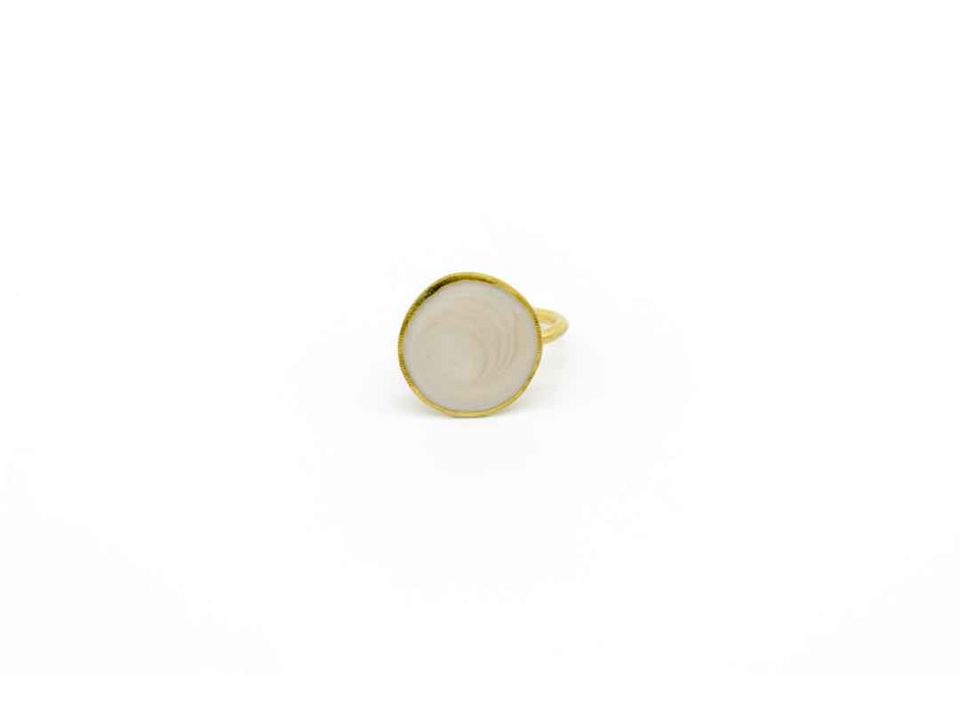 Handmade ring forged round design on white pearl.