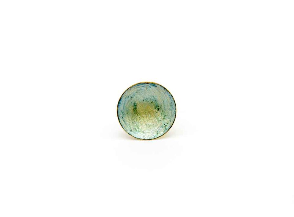 Handmade ring on a gold base with a concave blue-green element.