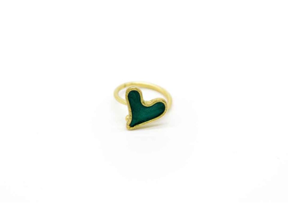 Handmade forged ring on gold base of small green heart.