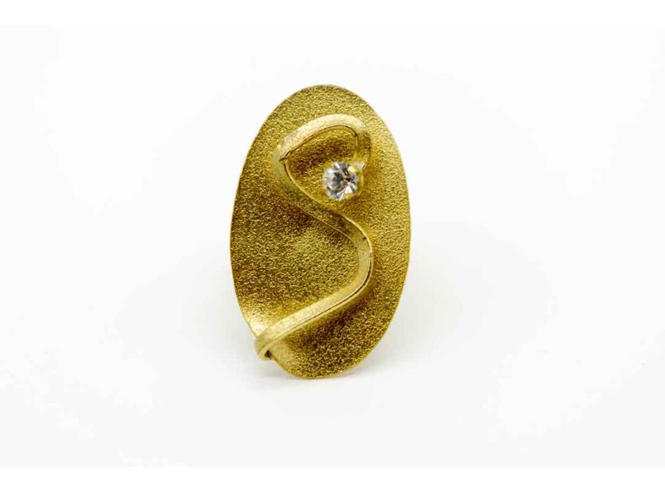 Handmade forged gold color ring in oval with transparent rhinestones.