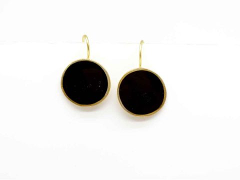 Handmade forged round earring in black color.