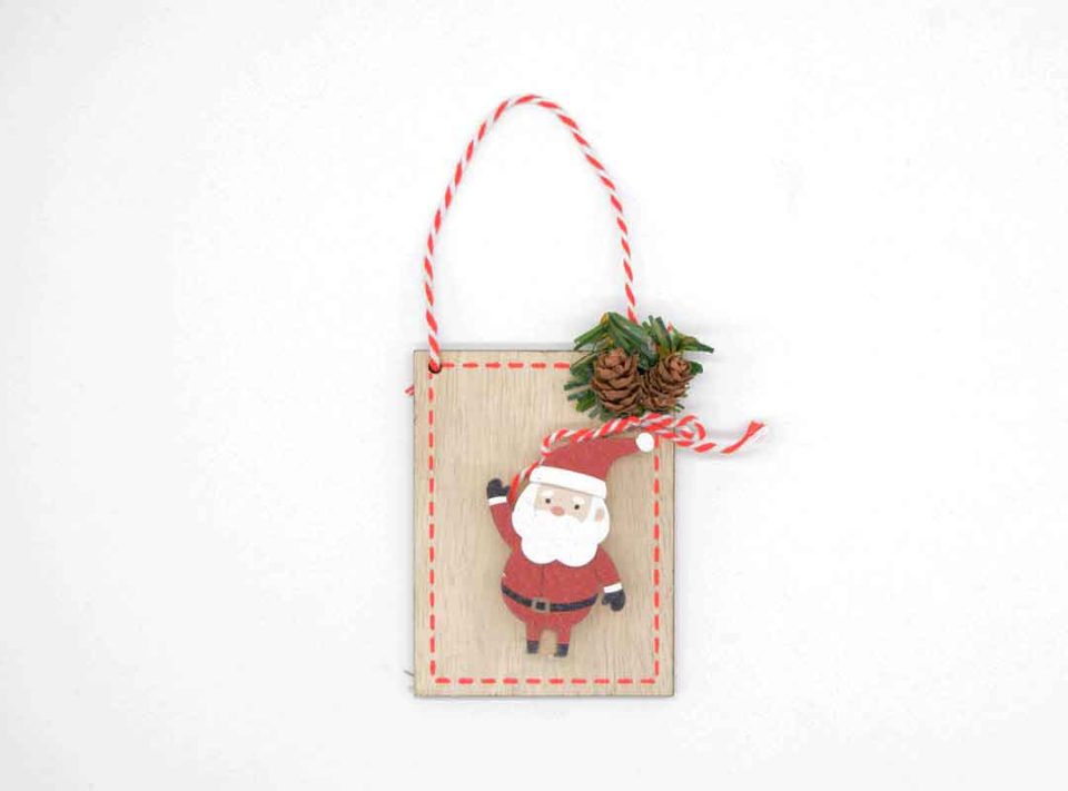 Handmade wooden ornament with Santa Claus peg.