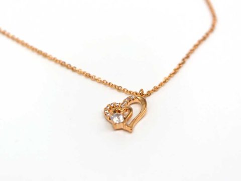 Short steel necklace in rose gold with two hearts on top of each other with rhinestones