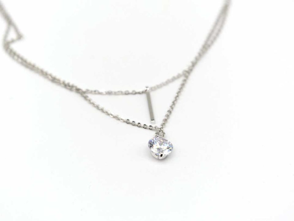 Double steel necklace in silver color with a metal rod and a rhinestone.