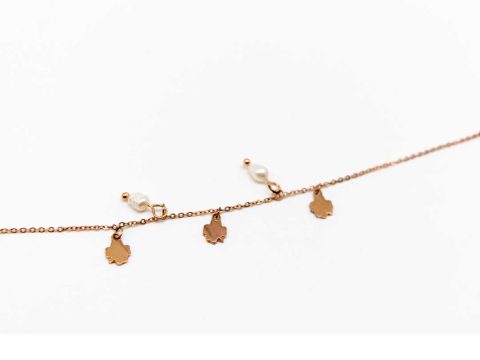 Steel bracelet in rose gold color with three crosses and three pearls