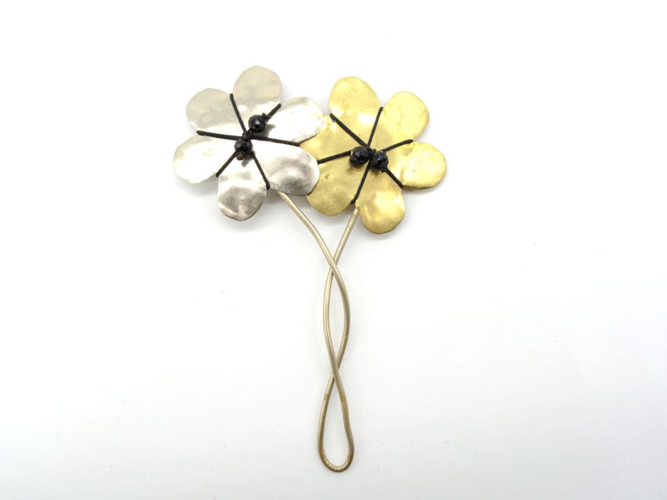 Handmade brooch with two small flowers, one in gold and one in silver