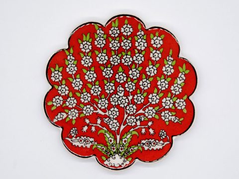 Ceramic coaster round with curves, in red color with fine white flowers