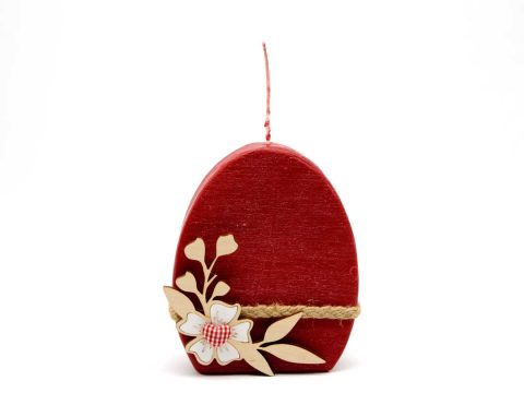 Handmade scented decorative candle flat egg in red with wooden flower.