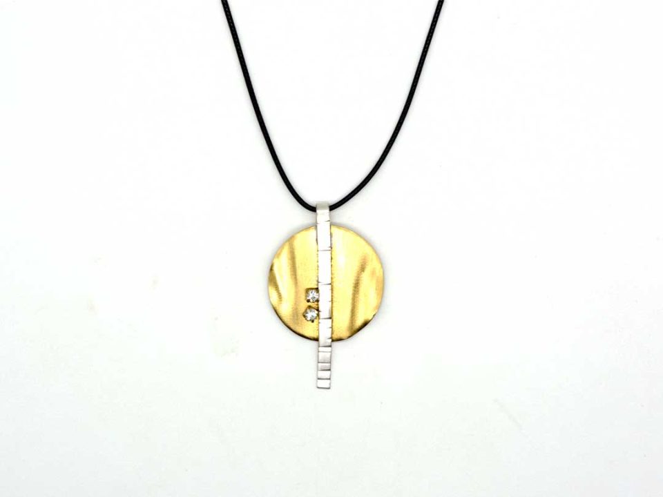 necklace a special forged round gold color with silver bar.