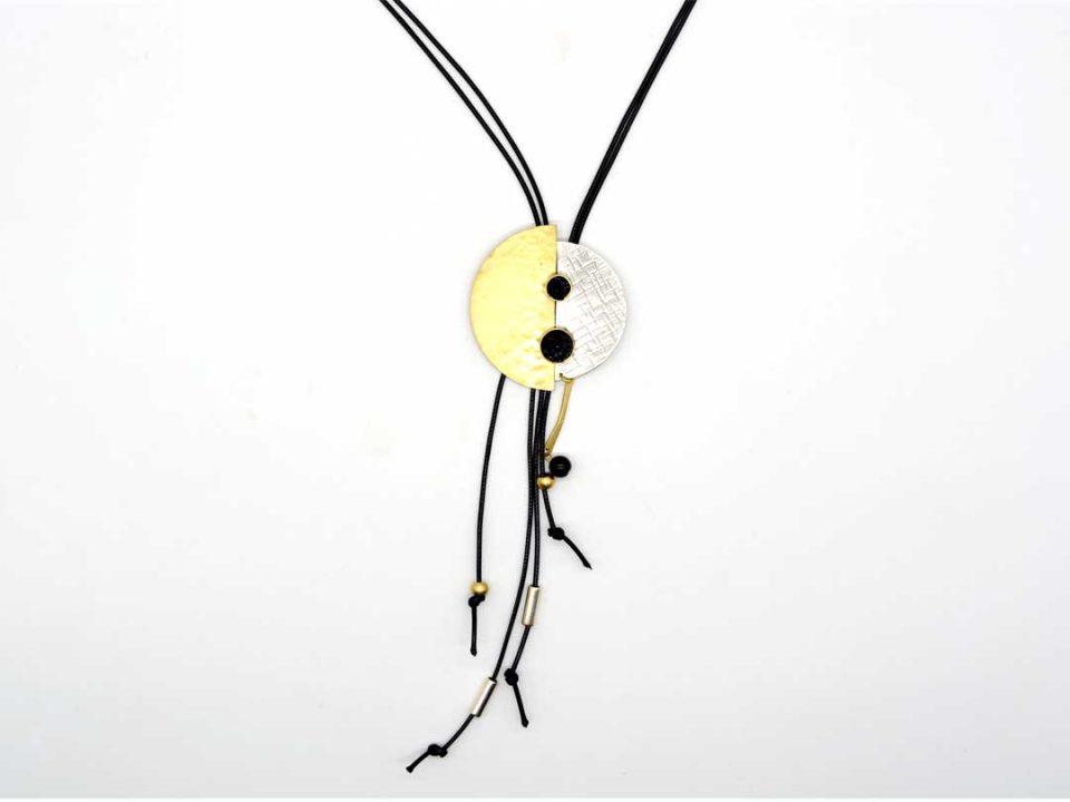 necklace forged round silver element with gold and black gems