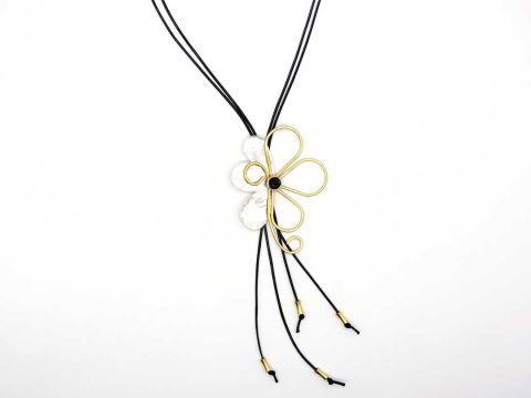 Large forged silver flower necklace with gold and green gems.