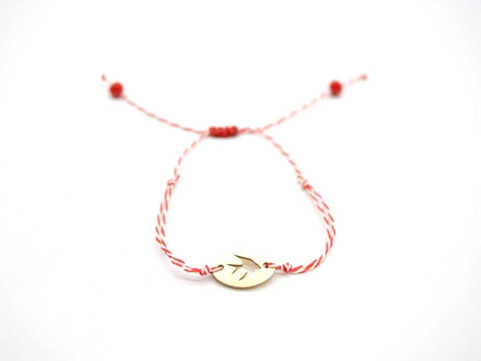 Handmade March bracelet, with oval element with swallow in gold.