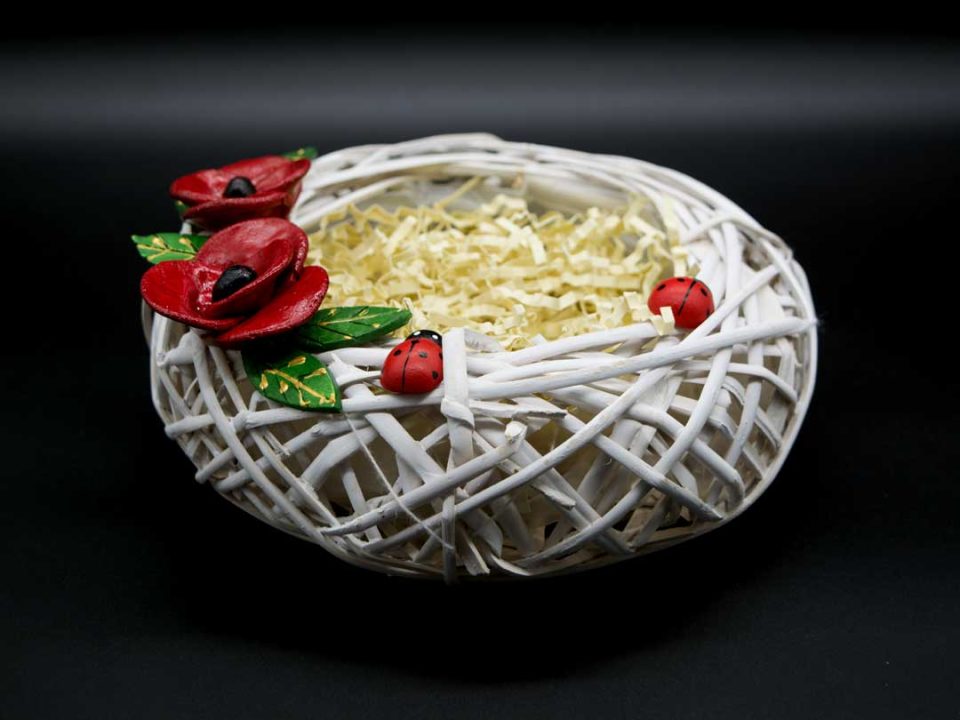 Handmade nest for eggs with ceramic poppies.