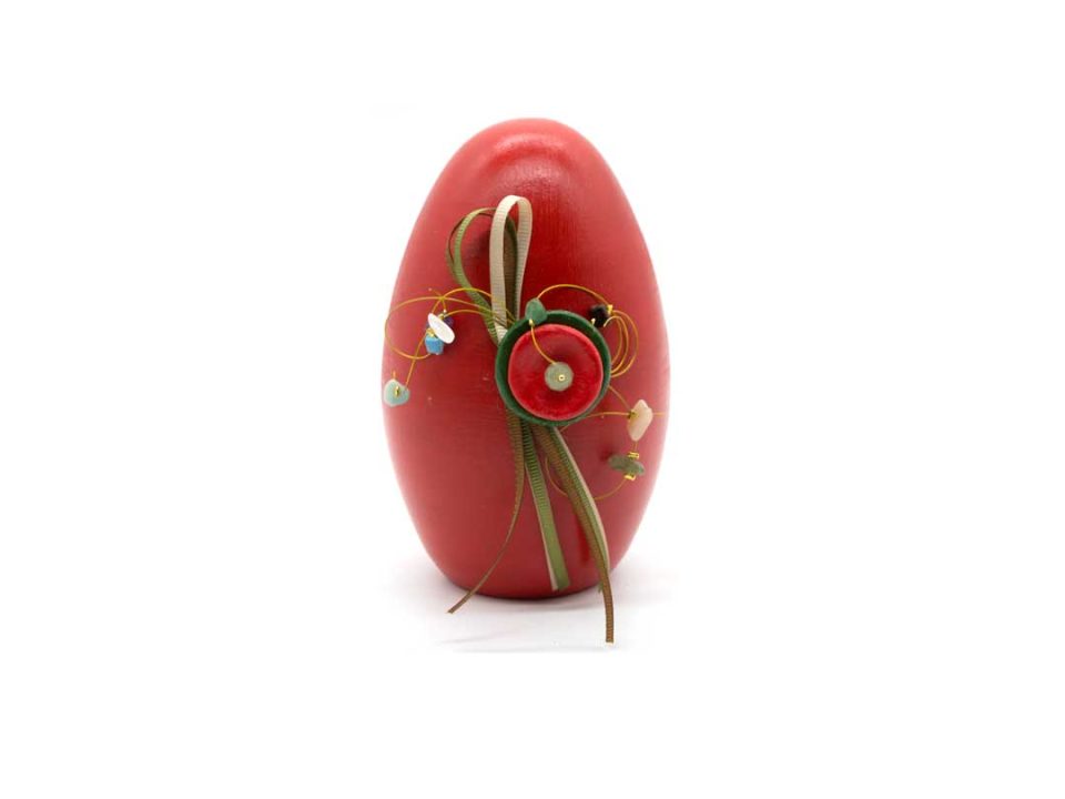 Handmade ceramic egg, red with green decoration.