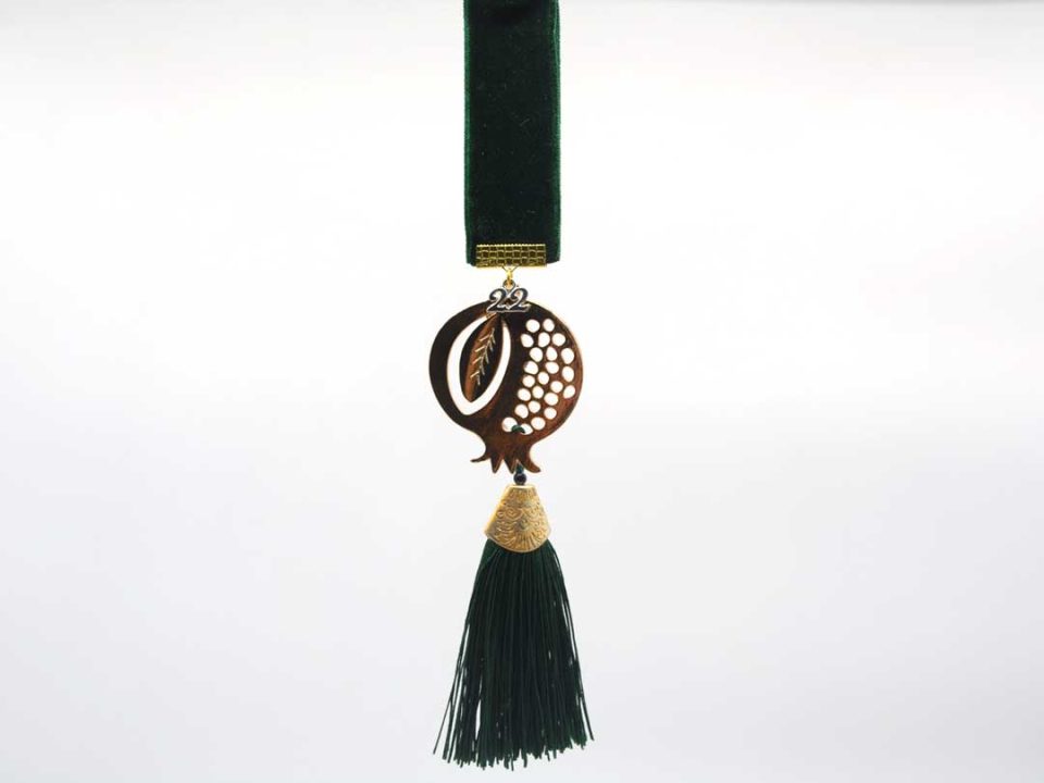 Handmade golden metallic pomegranate charm with green tassel