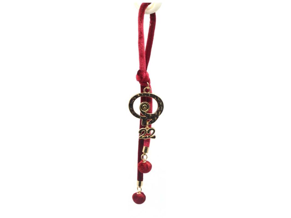 Handmade charm with metallic gold pomegranate perforated tied in burgundy