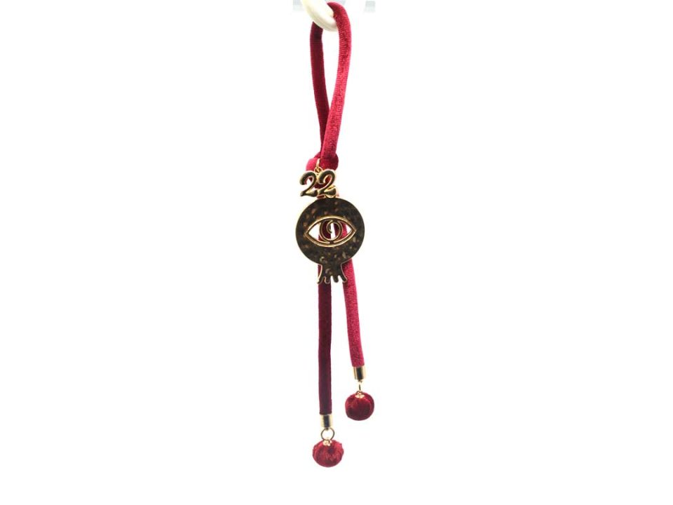 Handmade charm with metallic gold pomegranate perforated with blindfold